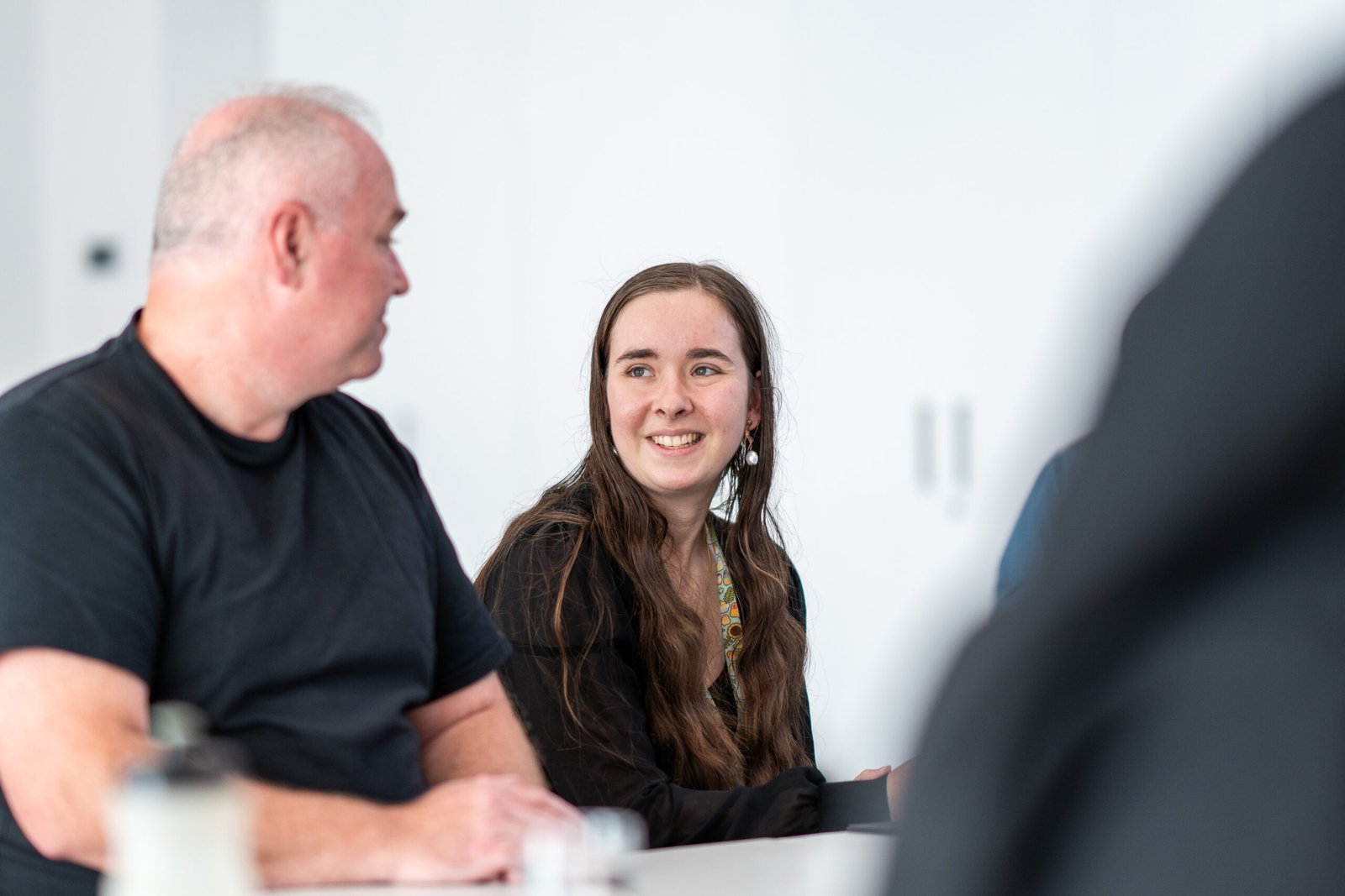 Two attendees in conversation at the Make It 16 event