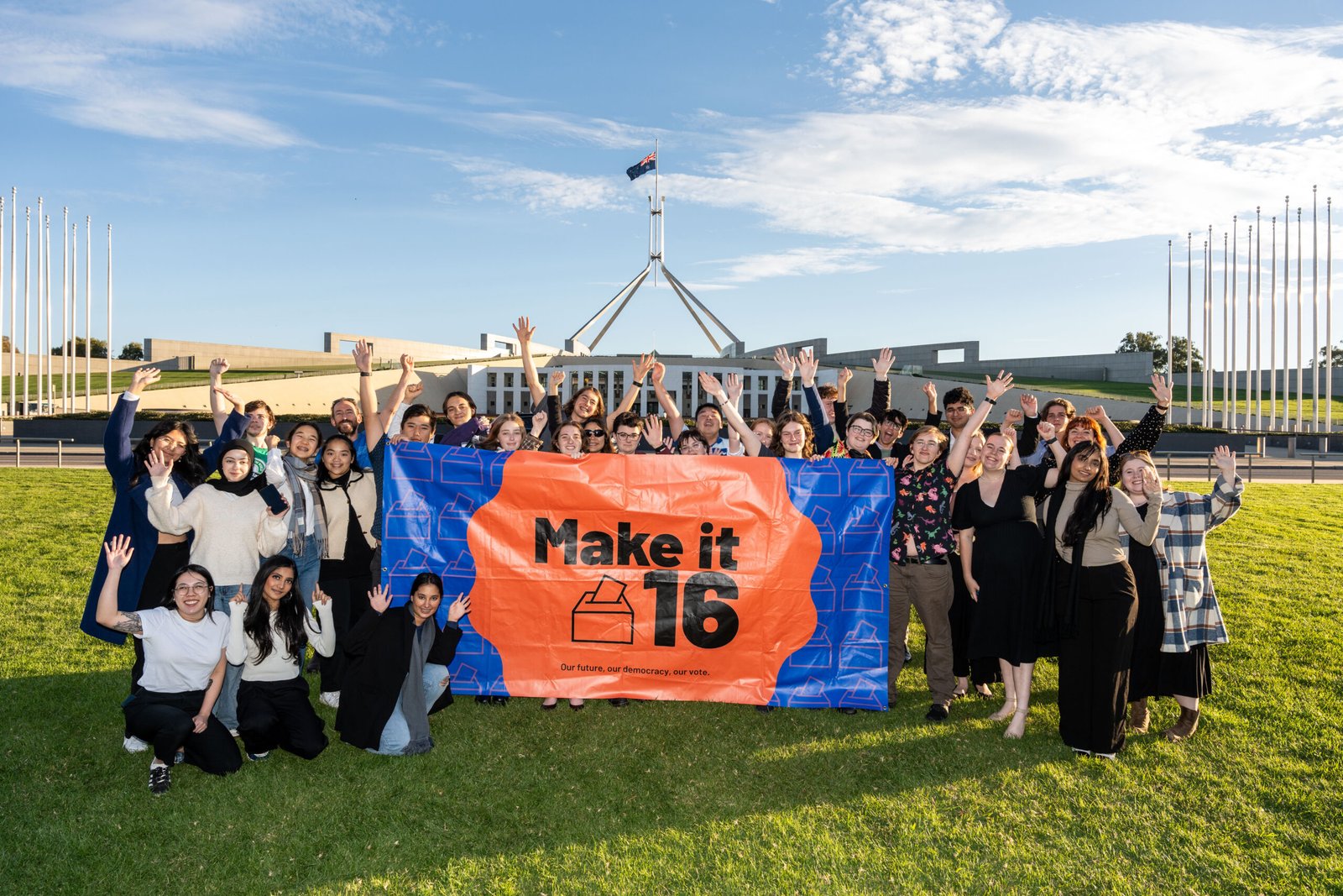 Young campaigners holding the Make It 16 banner in front of Parliament House in Canberra